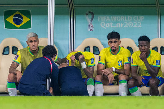 Neymar of Brazil receives medical attention