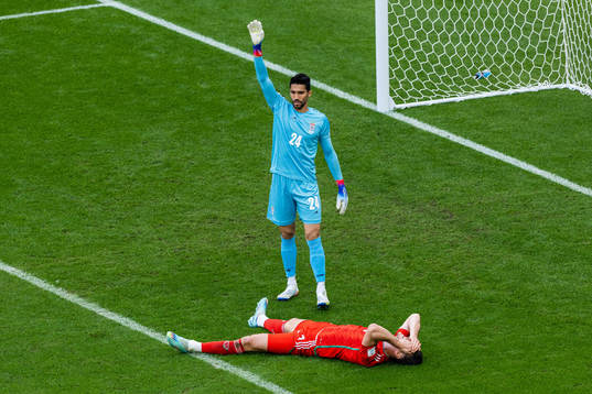 goalkeeper Hossein Hosseini of Iran and Kieffer Moore of