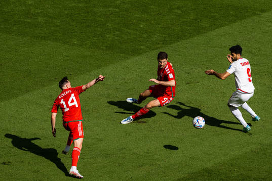 Connor Roberts and Ben Davies of Wales against Mehdi Taremi