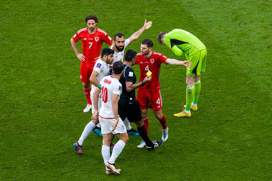 Karim Ansarifard of Iran with Joe Allen and Ben Davies of