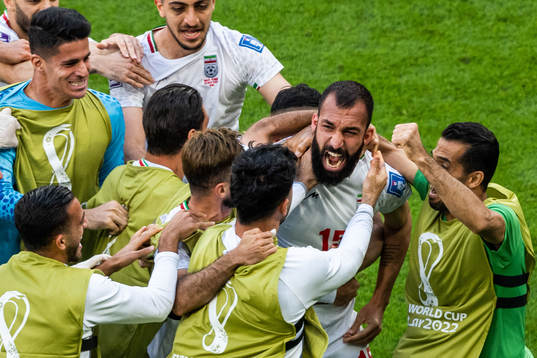 Rouzbeh Cheshmi of Iran celebrates with team mates