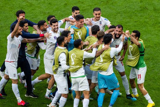 Rouzbeh Cheshmi of Iran celebrates with team mates