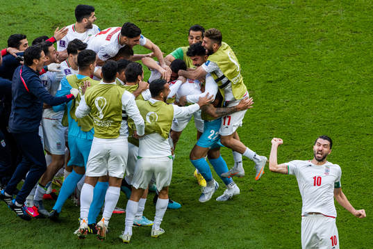 Rouzbeh Cheshmi of Iran celebrates with team mates