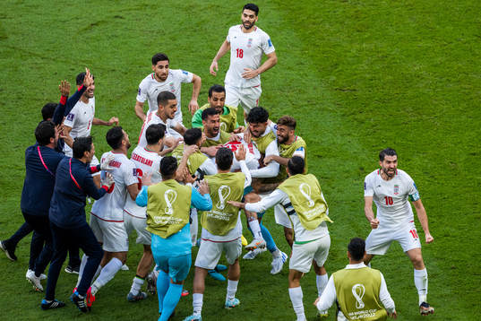 Rouzbeh Cheshmi of Iran celebrates with team mates