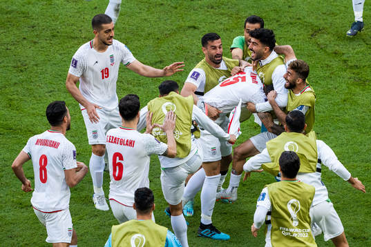 Rouzbeh Cheshmi of Iran celebrates with team mates