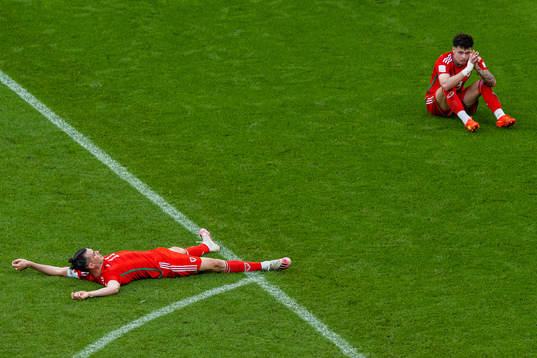 Gareth Bale and Neco Williams of Wales look dejected