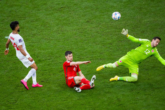 Ramin Rezaeian of Iran scores 0-2 behind Ben Davies and