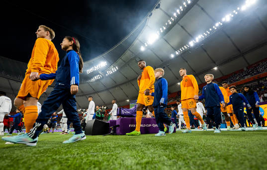 Players of Netherlands and of Ecuador enter the field for