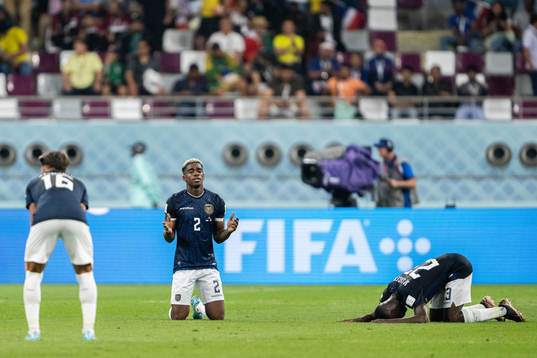 Felix Torres and Moises Caicedo of Ecuador pray