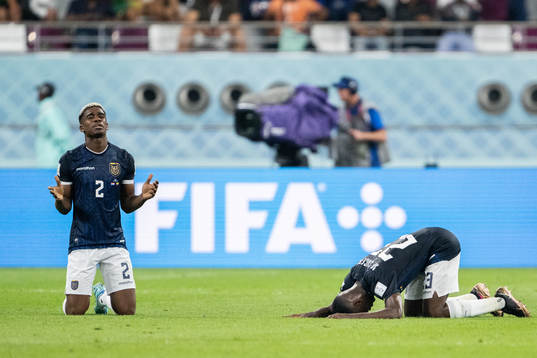 Felix Torres and Moises Caicedo of Ecuador pray