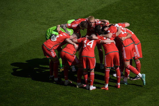 The players of Wales huddle