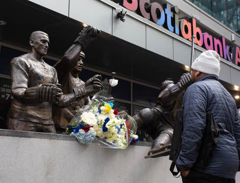 A passerby takes a moment at a statue of the late Börje