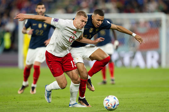 Rasmus Kristensen of Denmark and Kylian Mbappe of France