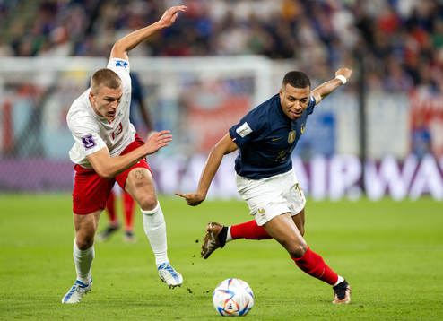 Rasmus Kristensen of Denmark and Kylian Mbappe of France