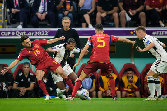 Jordi Alba and Sergio Busquets of Spain are being