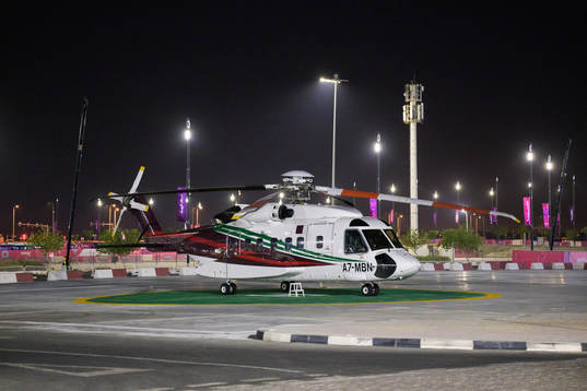 A helicopter parked outside Al Bayt Stadium