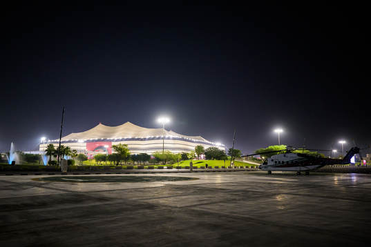 A helicopter parked outside Al Bayt Stadium