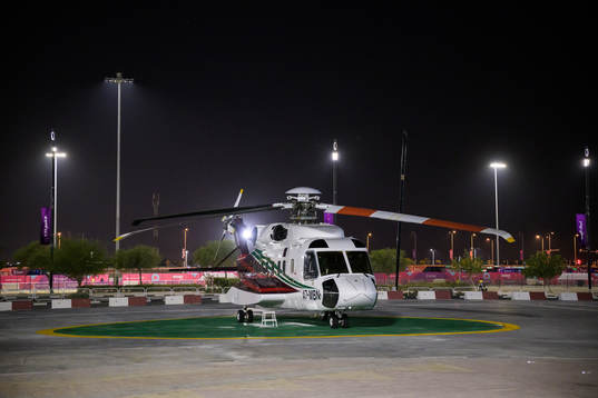 A helicopter parked outside Al Bayt Stadium