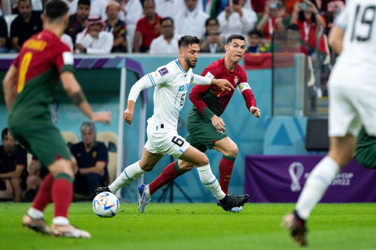 Rodrigo Bentancur of Uruguay and Cristiano Ronaldo of