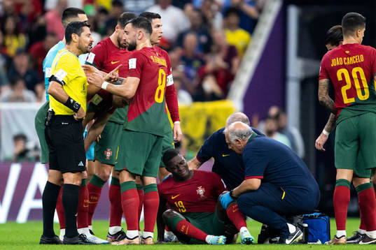 Nuno Mendes of Portugal receives medical attention