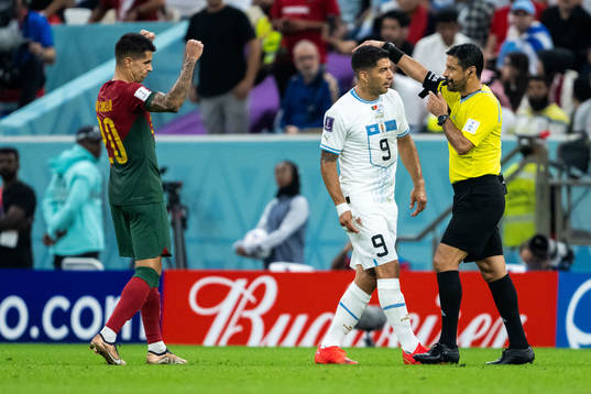 Joao Cancelo of Portugal celebrates, Luis Suarez of Uruguay
