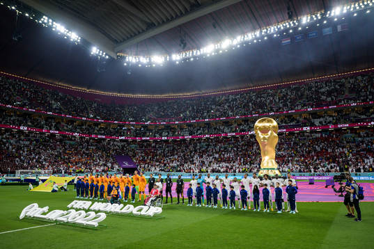 Players of Netherlands and of Qatar line up