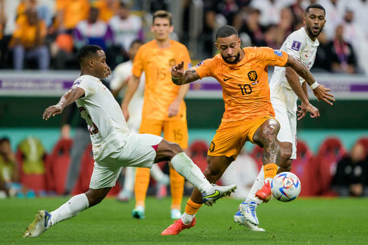 Assim Madibo of Qatar against Memphis Depay of Netherlands