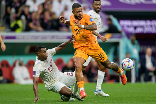 Assim Madibo of Qatar against Memphis Depay of Netherlands