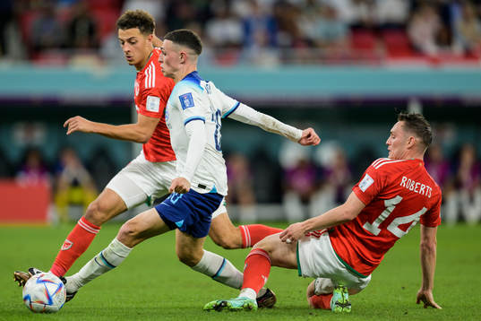 Ethan Ampadu and Connor Roberts of Wales against Phil Foden