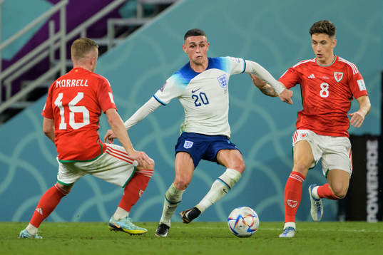 Joe Morrell and Harry Wilson of Wales against Phil Foden of
