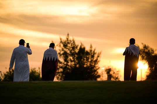 Men take pictures of the sunset