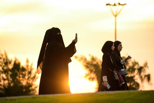 A woman in niqab walks towards the arena