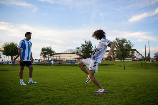 Two people play football