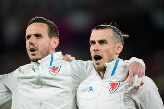 Goalkeeper Danny Ward and Gareth Bale of Wales singing the