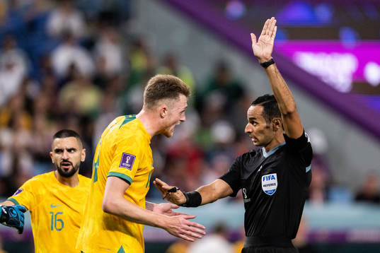 Harry Souttar of Australia and referee Mustapha Ghorbal