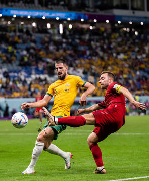 Milos Degenek of Australia and Christian Eriksen of Denmark