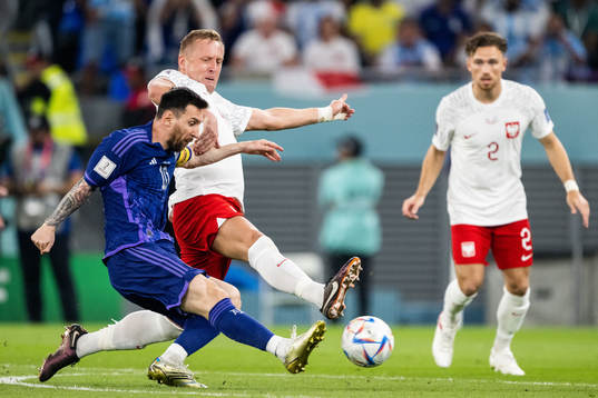 Lionel Messi of Argentina and Kamil Glik of Poland