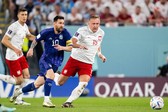 Lionel Messi of Argentina and Kamil Glik of Poland