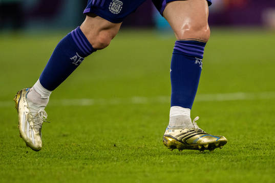 Detailed view of the golden boots of Lionel Messi of