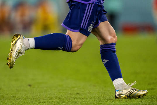 Detailed view of the golden boots of Lionel Messi of