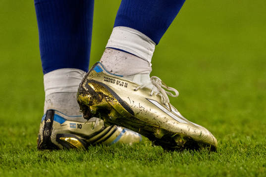 Detailed view of the golden boots of Lionel Messi of