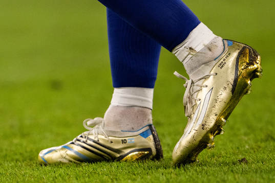 Detailed view of the golden boots of Lionel Messi of