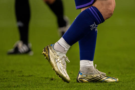 Detailed view of the golden boots of Lionel Messi of