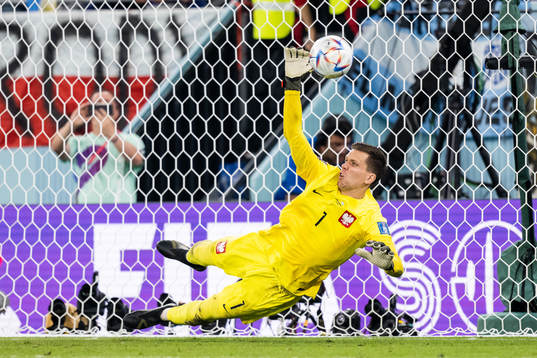 Goalkeeper Wojciech Szczesny of Poland saves a penalty