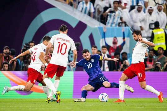 Lionel Messi of Argentina against Jakub Kiwior and Bartosz