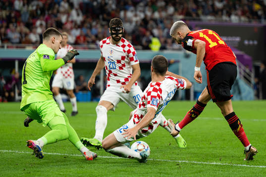 Yannick Carrasco of Belgium against goalkeeper Dominik