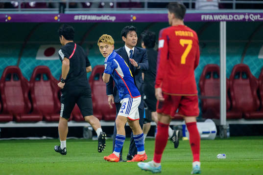 Ritsu Doan and head coach Hajime Moriyasu of Japan celebrate