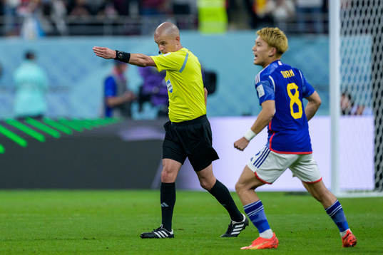 Referee Victor Gomes signals for goal scored by Ao Tanaka