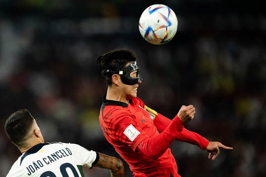 Joao Cancelo of Portugal and Heungmin Son of South Korea
