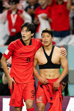 Guesung Cho and Heechan Hwang of South Korea celebrate the